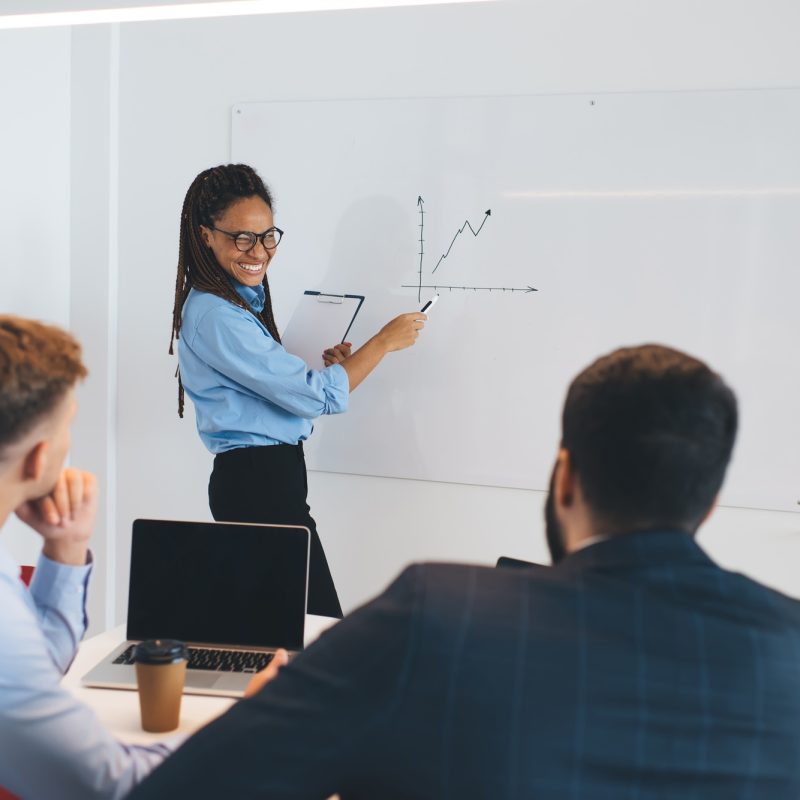 Cheerful business woman in spectacles making office presentation Cheerful business woman in spectacles making office presentation